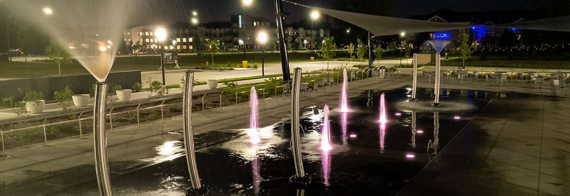 side view of Johnston Town Center at night with LED water sprayers and special effects