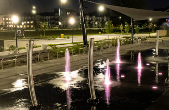 side view of Johnston Town Center at night with LED water sprayers and special effects