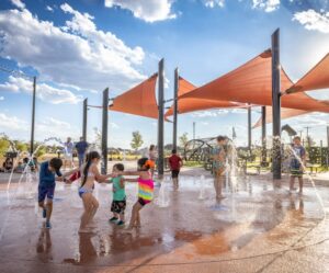 Triangular shade sails over Ward County Event Center splash pad