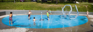 Nesbitt Preserve Park Splash Pad hero image with children playing in ground sprays