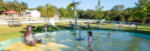 Woodway Splash Pad photo with little girl playing in ground spray