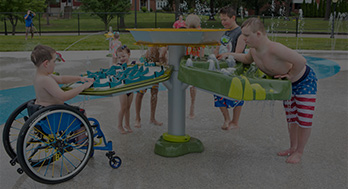 Children gather around a three-part water activity table