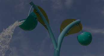 Looking up at two splash buckets at a spray park