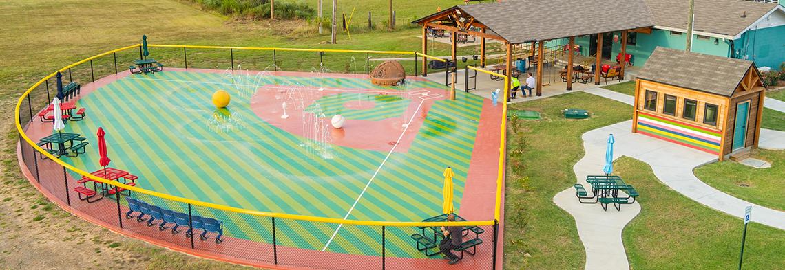 Landscape image of a splash pad designed to look like a baseball diamond