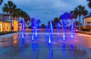 Purple LED lights show from ground sprays at a public mall