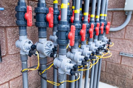 Manifold for a domestic single-pass water delivery system at a splash pad